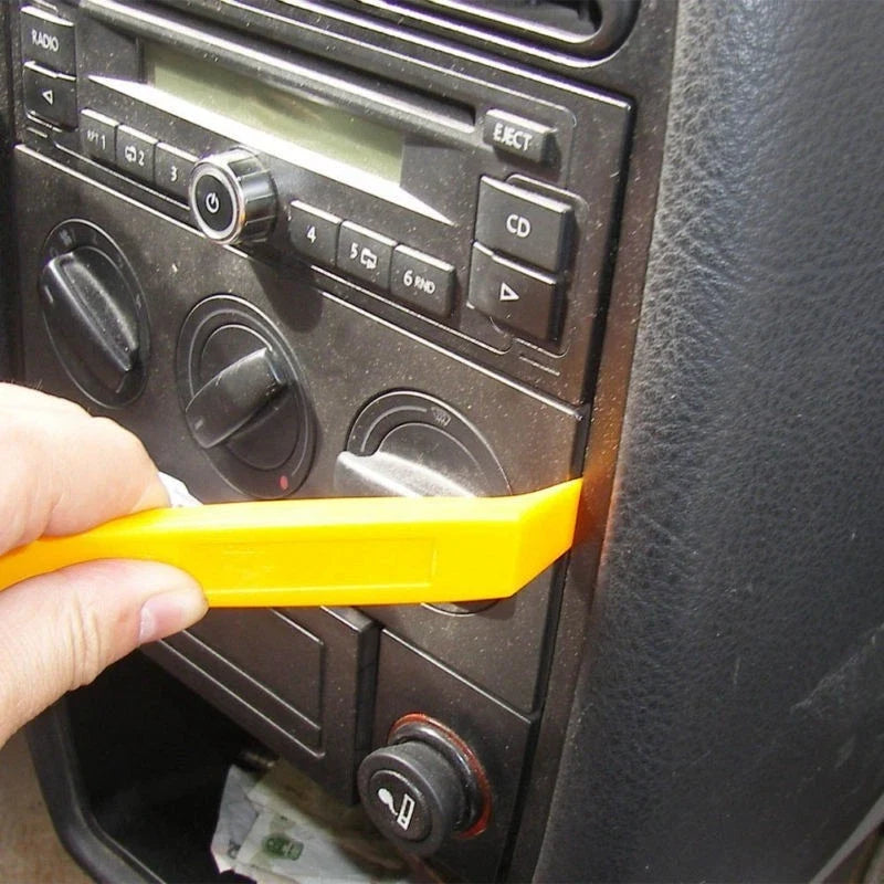 Example of careful trim-panel access using a plastic pry tool