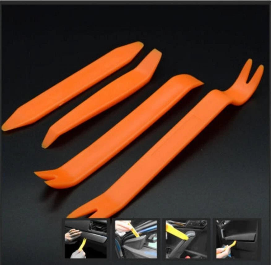 Four orange trim removal tools